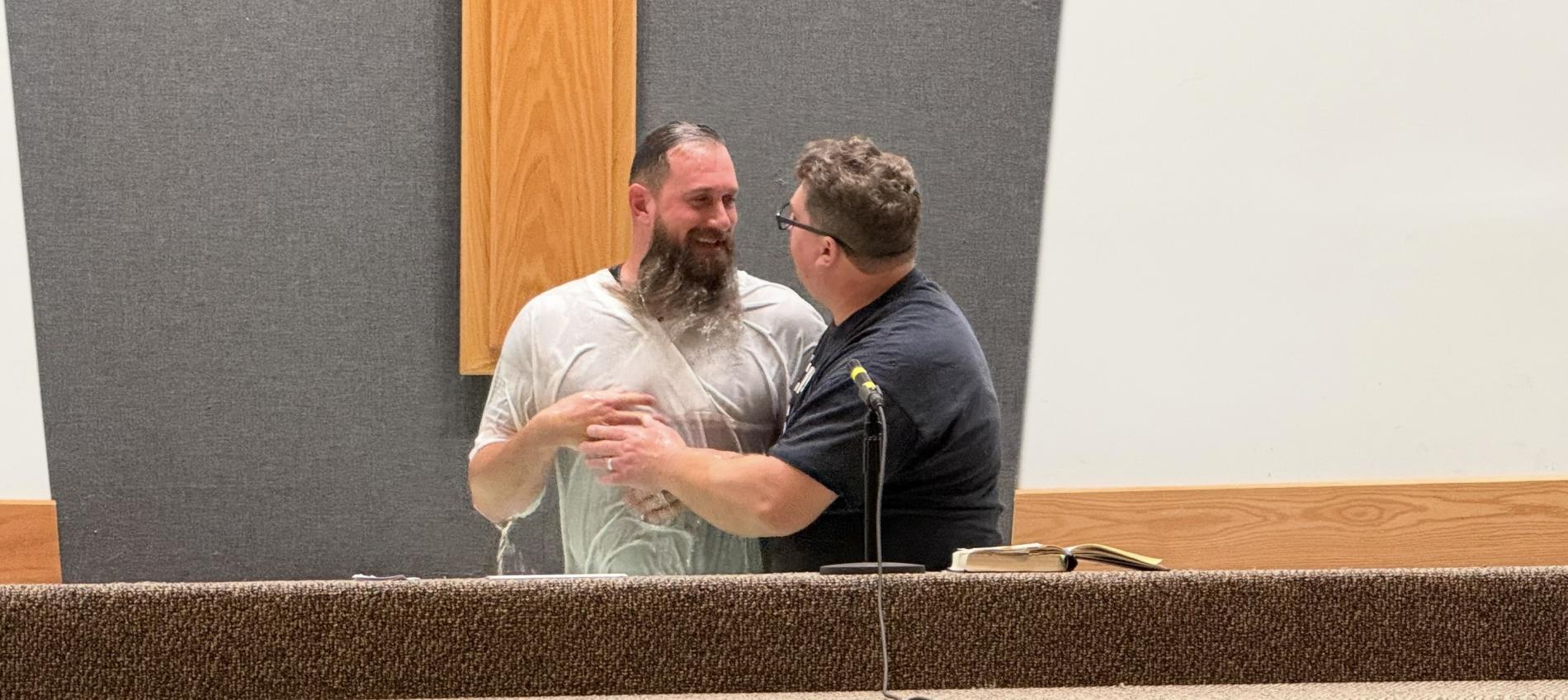 Man being baptized in a church setting.