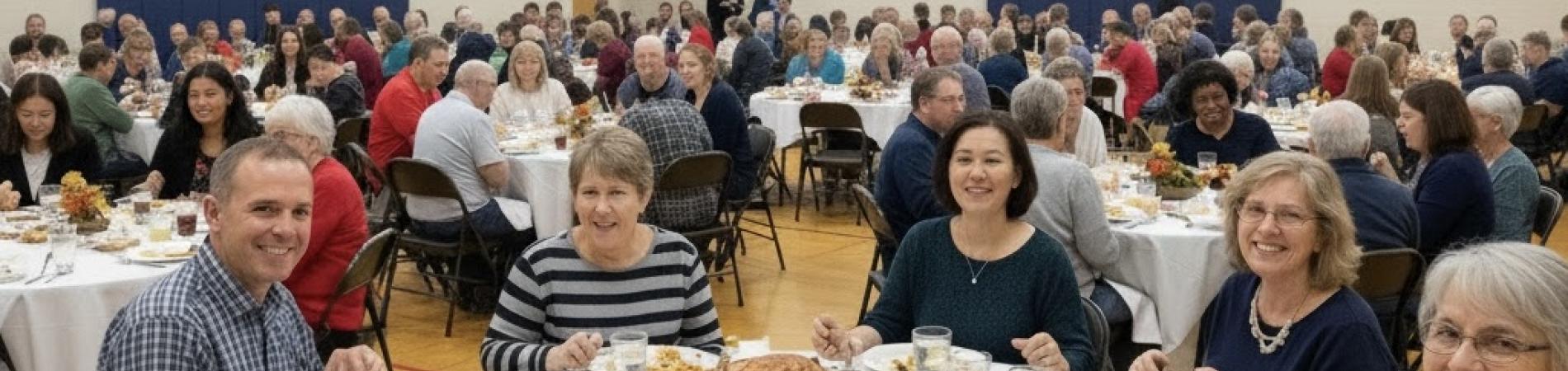 People enjoying a Thanksgiving meal at a community event.